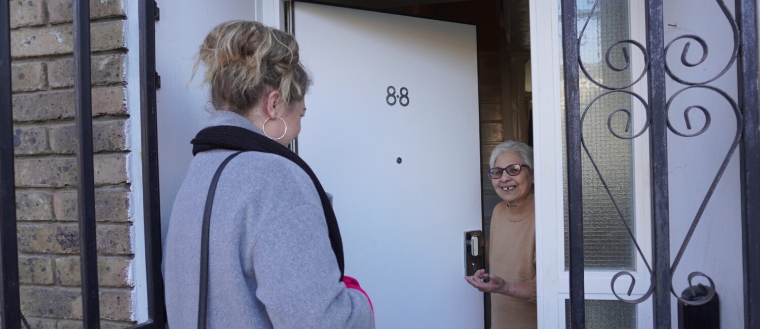 Simona, from our Safeguarding team, knocking on a resident's door